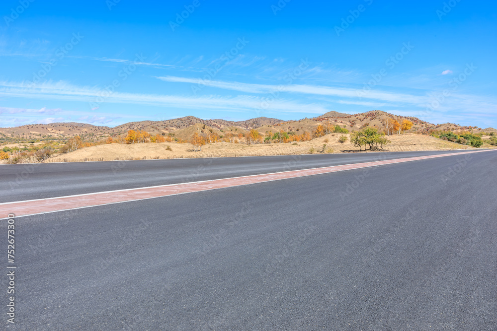 Asphalt highway road and mountain natural landscape under the blue sky Asphalt highway road and mountain natural landscape under the blue sky