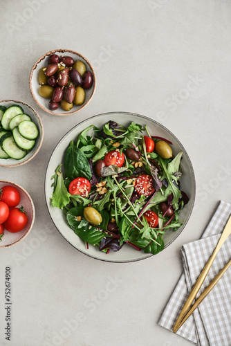 Salad with cherry tomato,  olives, cucumber and arugula