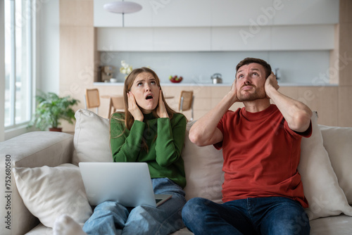 Slika na platnu Man and woman annoyed terrible noise neighbours upstairs renovating