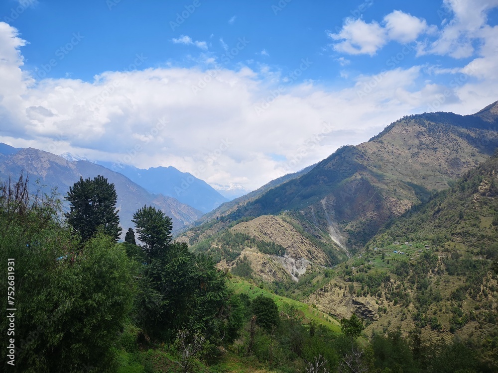 A picturesque valley, adorned with lush greenery, nestled between majestic mountains