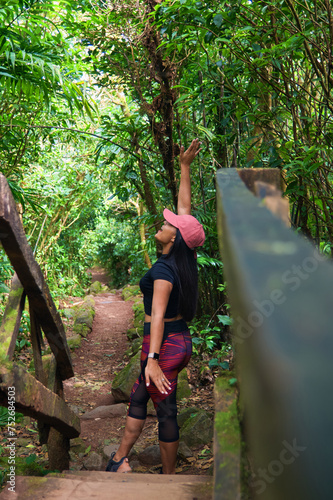 Happy young woman wearing sportswear at the Mombacho volcano nature reserve photo