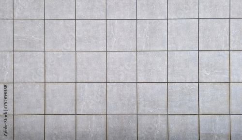 Top view of exterior ceramic floor with concrete or gray cement effect. Non-slip grey square terrace and porch tiles texture or background.