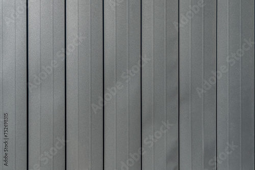 Texture of black metal standing seam facade. Minimalist building exterior design. Metal wall rebated panels as background photo
