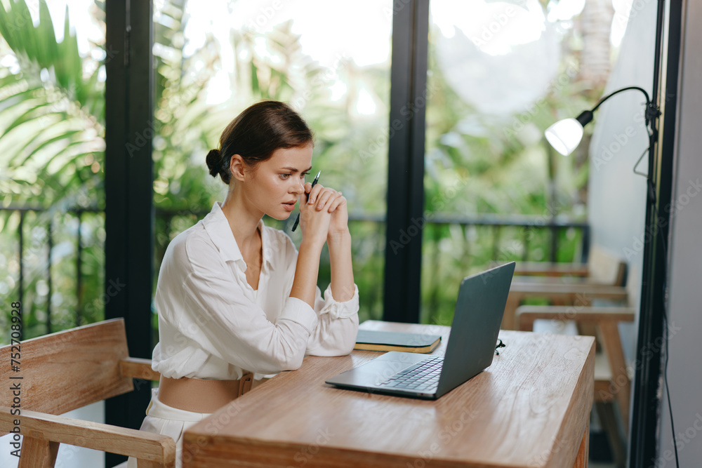 Smiling Young Woman Typing on Laptop at her Home Office Smiling Young Woman Typing on Laptop at her Home Office