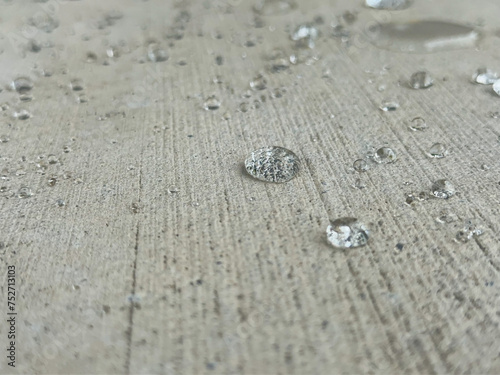 Close-up shot of water droplets on a concrete slab