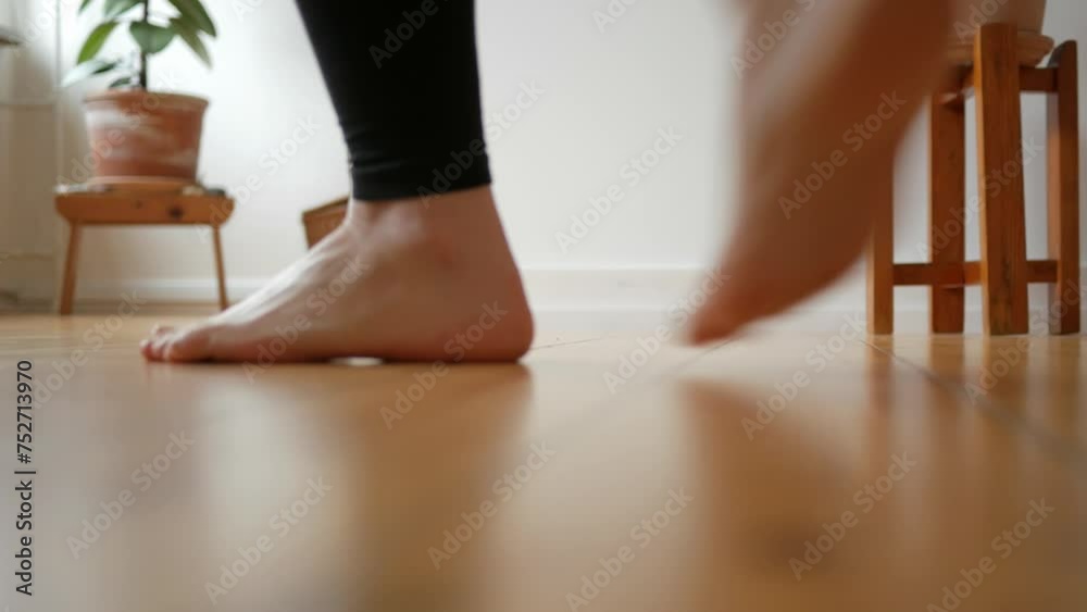 Women feet dancing barefoot on wooden floor in apartment Women feet dancing barefoot on wooden floor in apartment
