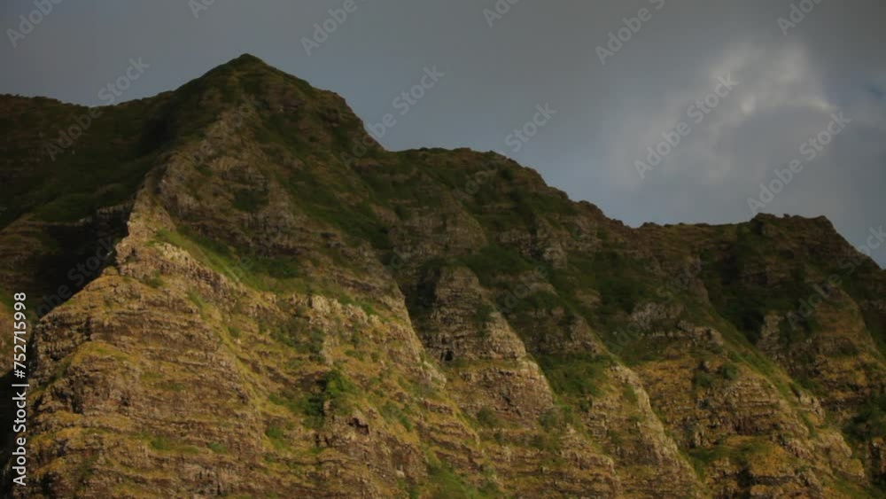 Sunset glow on tall Hawaiian mountain and shadows Sunset glow on tall Hawaiian mountain and shadows