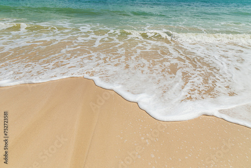 Beautiful white foam soft wave splashing on empty beach coastline summer holidays concept