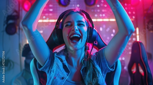 A Female eSports gamer rejoices in the victory in Neon game room background. high quality image photo