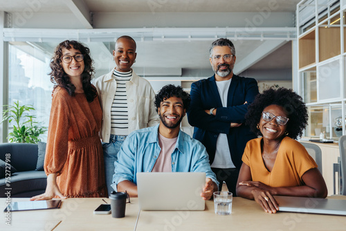 Portrait of a successful modern business team in a creative, collaborative office workspace photo