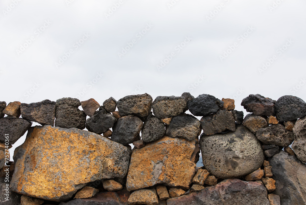 Jeju stone wall that forms the border of the field. Batdam Jeju stone wall that forms the border of the field. Batdam