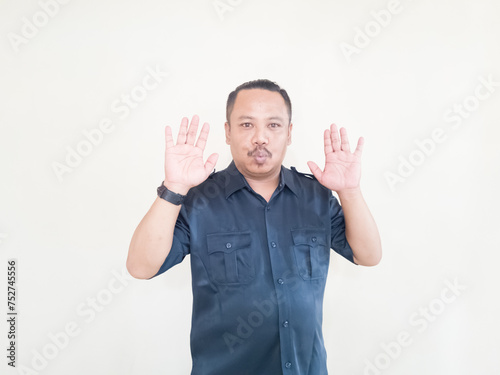 Expression of Asian man in blue uniform on white background © Jatmiko Harianto