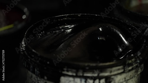 Screen printing ink mixing. Screen printing ink mixing stirrer. Mixing screen printing ink into the bucket