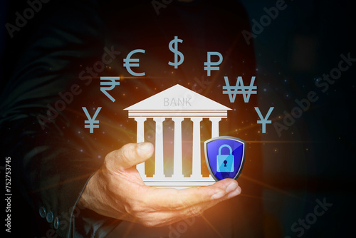 Businessman holding virtual bank icon with shield. Safety deposit and withdrawal, protected transactions money service with secure, finansial security photo