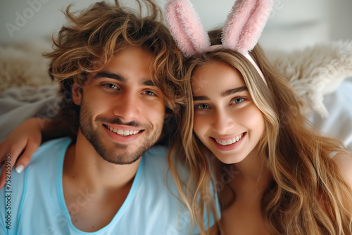 Happy couple in bunny ears on festive background. Easter concept photo