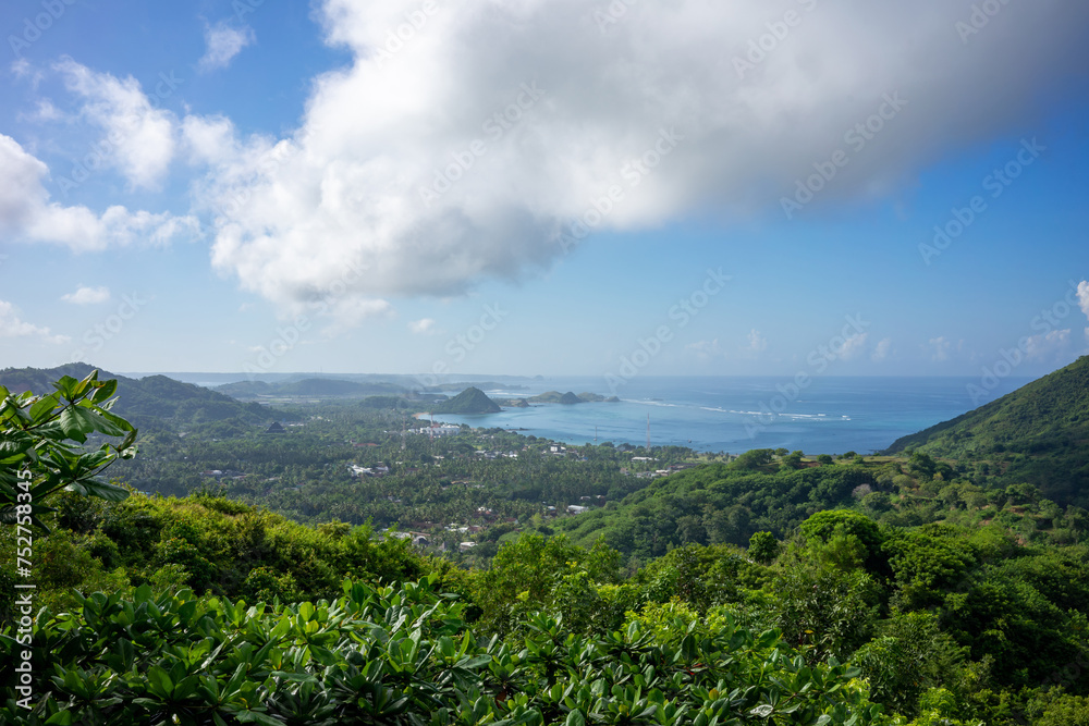 Breathtaking Panoramic View of Lombok's Lush Hills and Distant Ocean, Indonesia, Under a Clear Sky