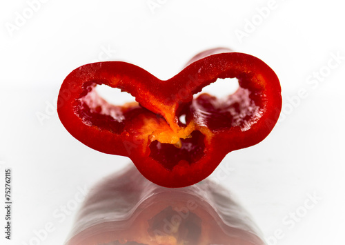 Cut of red bell pepper on white background