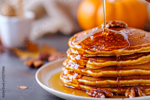 Delicious pumpkin pancakes, fluffy and golden, generously drizzled with sweet, golden honey. © Evgeniia