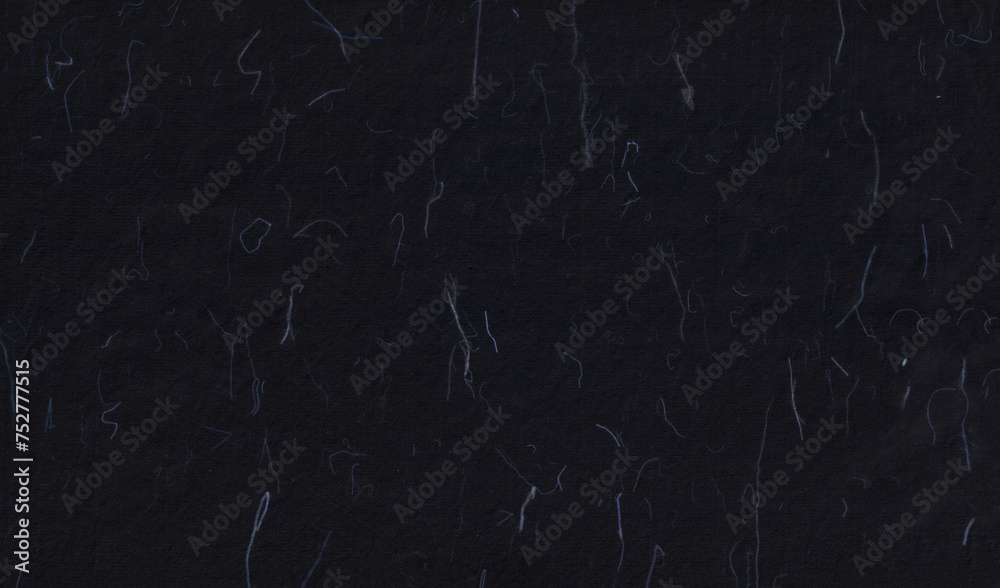 Hand made antique blank sheet black paper texture with blue fibers.