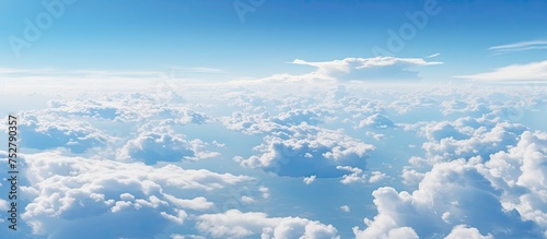 Limitless Horizon: A Serene Aerial View of the Clouds and Earth from High above in an Airplane photo