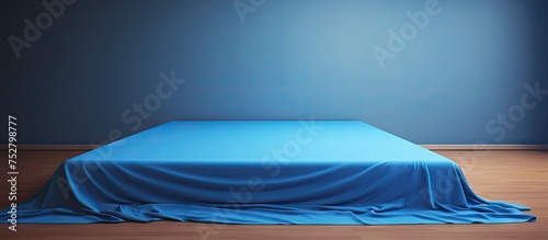 Tranquil Blue Sheet Resting on Rustic Wooden Floor, Minimalist Home Decor Concept photo