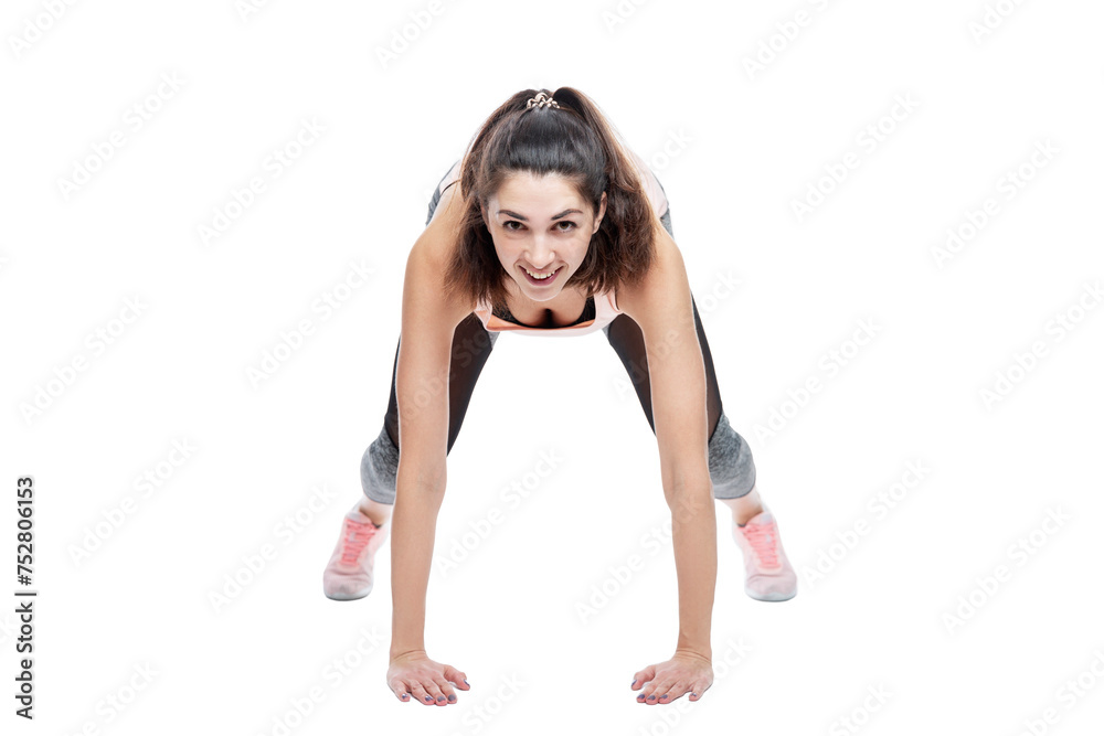 Smiling young woman in sportswear doing exercises. Beautiful brunette in a pink top. Activity, energy and health. Isolated on a white background. Smiling young woman in sportswear doing exercises. Beautiful brunette in a pink top. Activity, energy and health. Isolated on a white background.