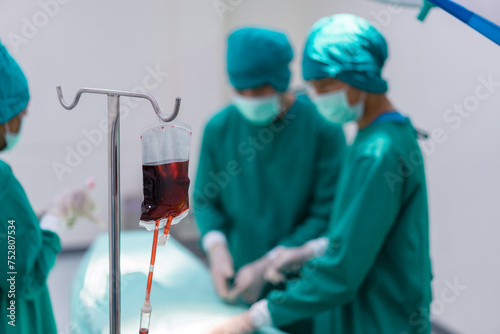 A bag of donated blood used during surgery. blood transfusion to a patient in the operating room.