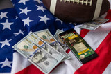 rugby ball and dollars with usa flag and smartphone bet