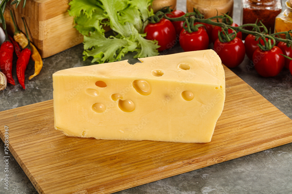 Swiss Maasdam cheese triangle over board Swiss Maasdam cheese triangle over board