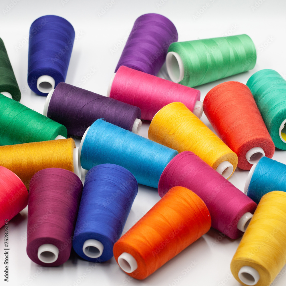 Thread spools background. Various colors sewing kit. Collection of threads. Vibrant vivid colors. Sew threads. Colorful hobby background. Thread spools background. Various colors sewing kit. Collection of threads. Vibrant vivid colors. Sew threads. Colorful hobby background.