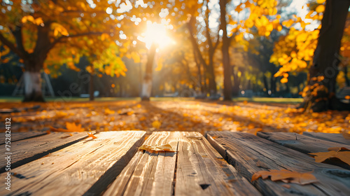 Empty wooden table in autumn park on sunny day ,