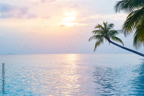 Vacation travel concept with tropical sunset or sunrise seascape horizon and green palms