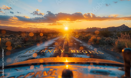 The open road through a desert at sunset with JOURNEY BEGINS written across the path, symbolizing new adventures and the start of a quest photo