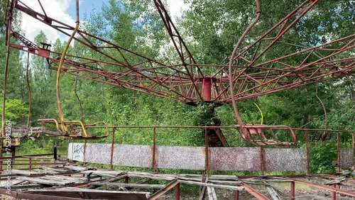 Eerie scene of an abandoned amusement park: a rusting merry-go-round overtaken by nature