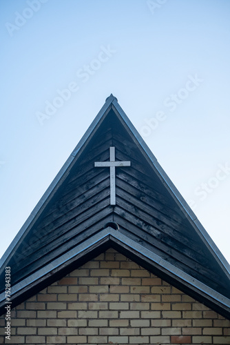 modern Christian church roof top with cross