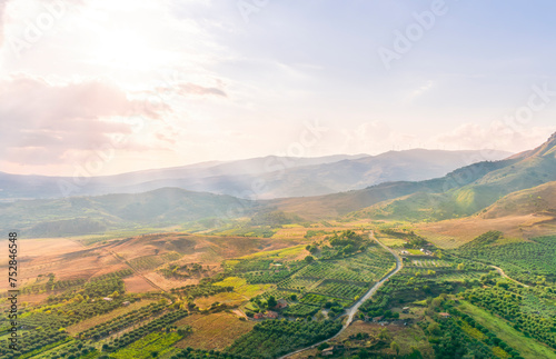 rustic landscape view of rural green valley in mountain hills with farms and gardens