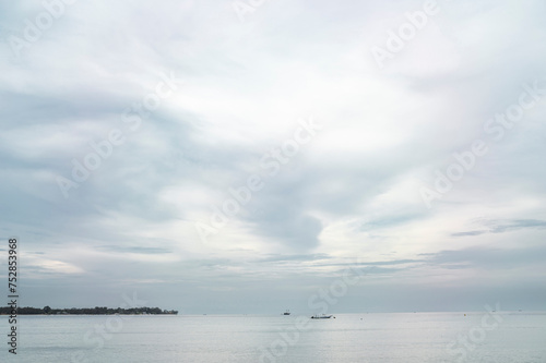 Soft Sky and Calm Sea with Distant Boats, Gili Island, Indonesia, Asia photo