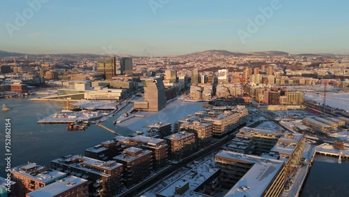 Golden Hour View Over Bjorvika In Sentrum borough of Oslo, Norway With Fog Floating Over Water. Aerial Rising Shot photo