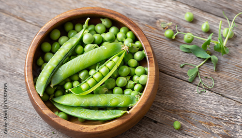 Cloce-up view of Hearthy fresh green peas and pods in wooden bowl on rustic background