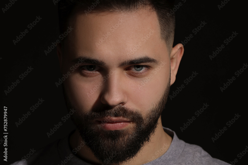 Evil eye. Man with scary eyes on black background