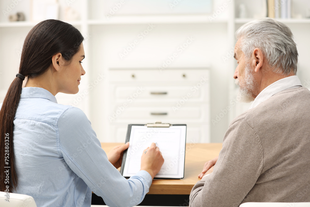 Notary consulting senior man about Last Will and Testament in office, back view Notary consulting senior man about Last Will and Testament in office, back view