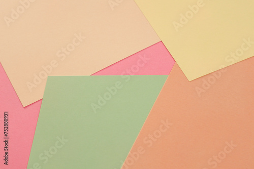 Multicolor background made of sheets. Pink, orange, green and yellow pastel color paper background. Texture for design. Flat lay, Top view. Copy space