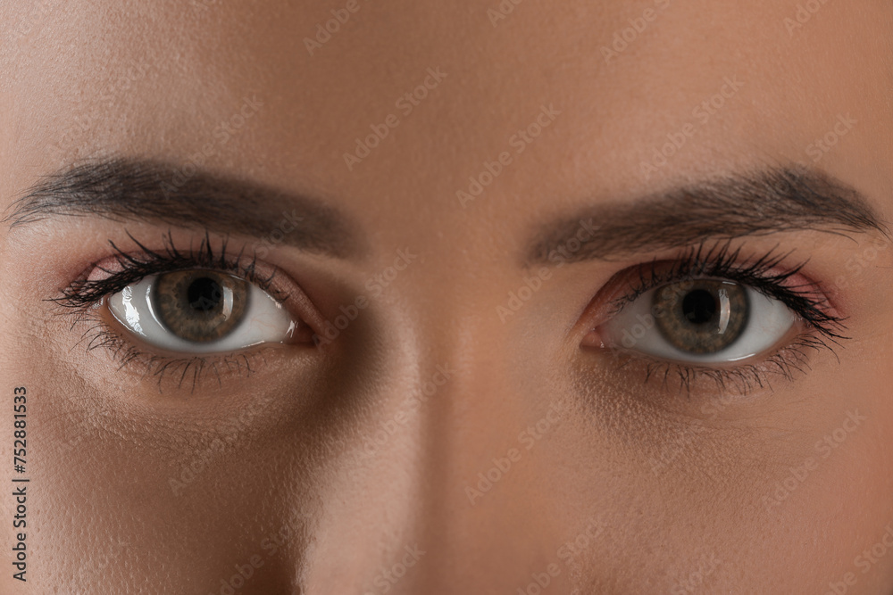 Fototapeta premium Evil eye. Young woman with scary eyes, closeup