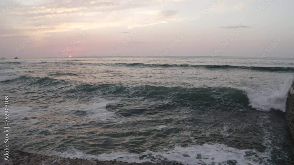 Ocean waves with setting sun over sea. Aerial forward at low altitude and sky for copy space Ocean waves with setting sun over sea. Aerial forward at low altitude and sky for copy space