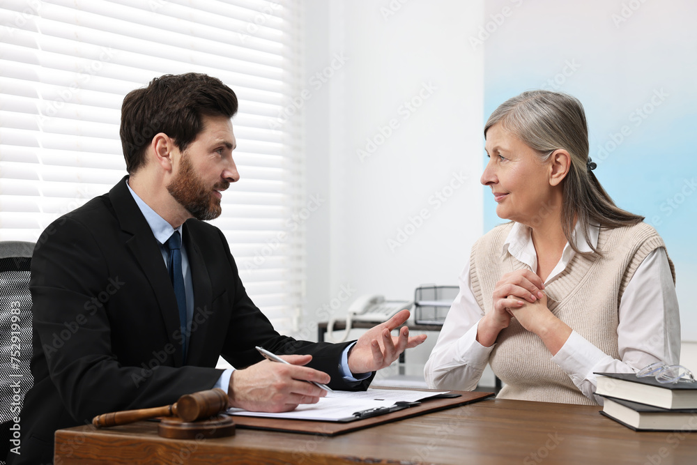 Senior woman having meeting with lawyer in office Senior woman having meeting with lawyer in office