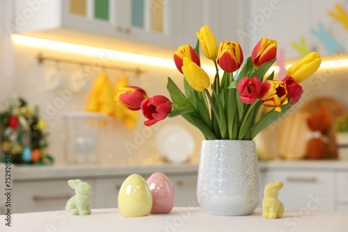 Bouquet of tulips and Easter decorations on white table indoors  closeup