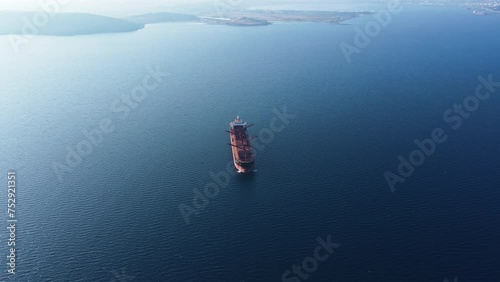 Dry bulk cargo carrier vessel anchored cleaning operation ship holds preparing for loading new dry cargo, aerial view