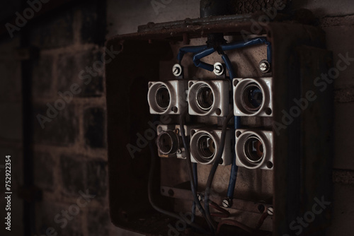 An old broken fuse board in a dark room