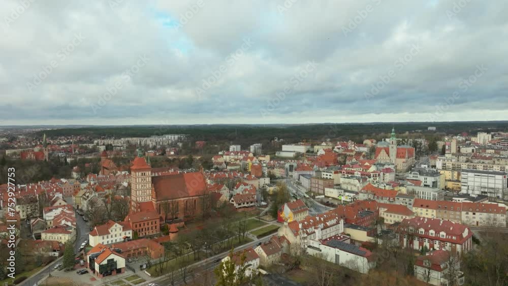 Historic polish town of Olsztyn with old town and buildings at cloudy day. Rising drone wide shot. Center of city located on hill. Panorama view. Historic polish town of Olsztyn with old town and buildings at cloudy day. Rising drone wide shot. Center of city located on hill. Panorama view.