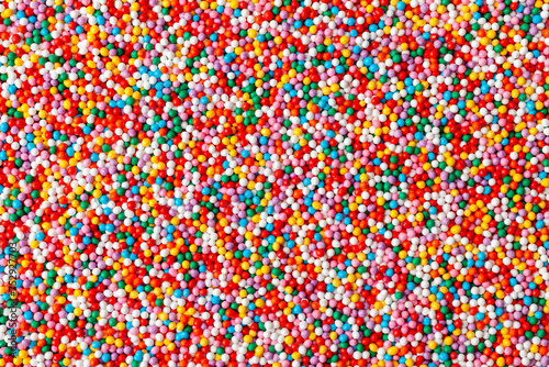 Confectionery sprinkles. Colorful background texture. Decoration for cake and bakery. Top view